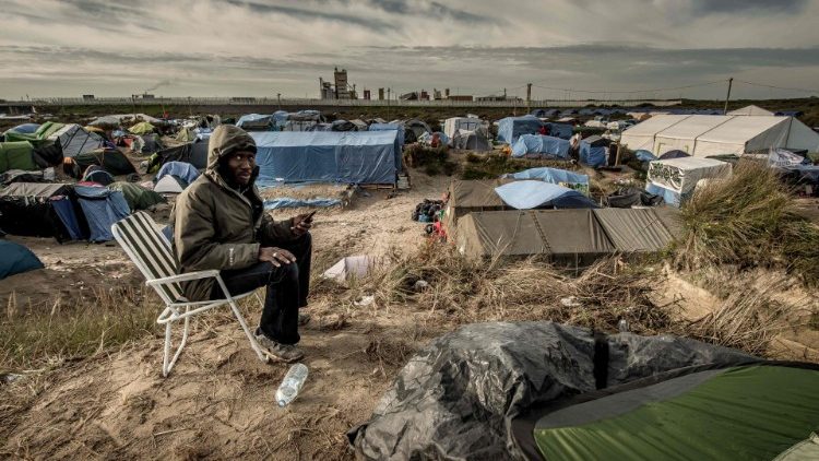 A Sudanese man calls his family from a migrant camp in Calais