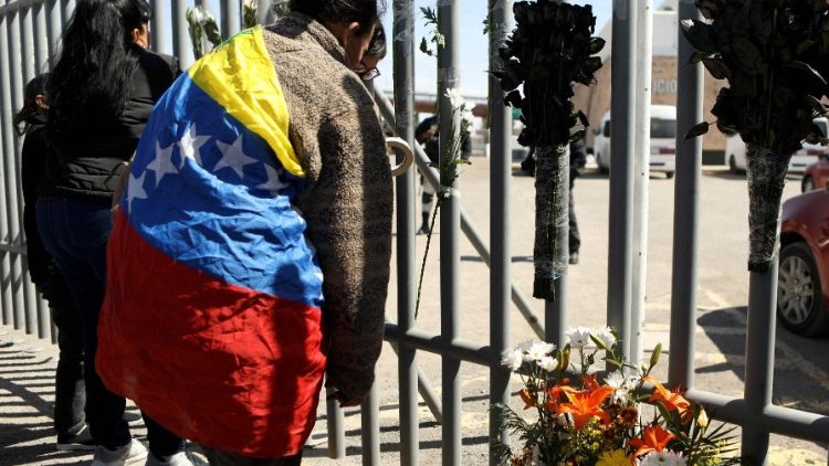 Venezuelan migrants bring flowers to the detention centre in Ciudad Juarez