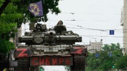 Members of the Wagner private army sit atop a tank in the Russian city of Rostov-on-Don on 24 June