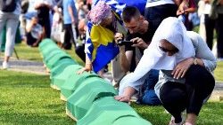  A Bosnian Muslim woman, survivor of the Srebrenica 1995 massacre mourns near the casket containing the remains of a relative and victim of the Srebrenica 1995