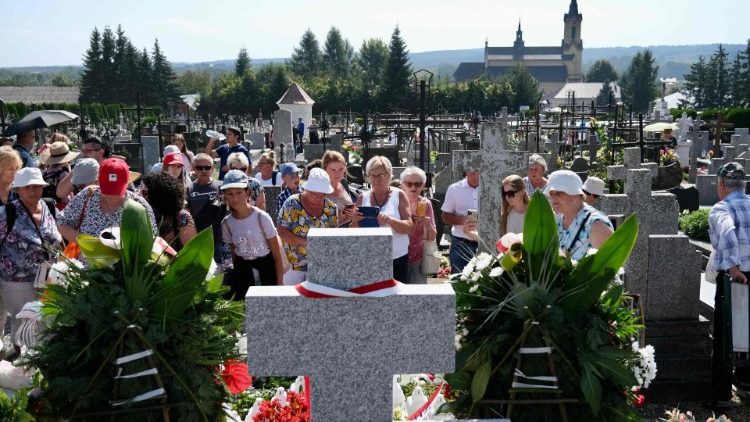 Pilgrims gather at the grave of the Ulma family in Markowa
