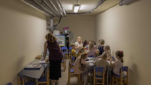 Children and their teachers wait in a school basement used as a bomb shelter during an air strike on Kryvyi Rih, Southern Ukraine