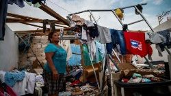 A lady stands at a destroyed house after the passage of Hurricane Otis on 27 October