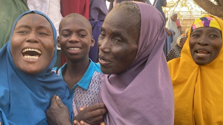 Women react as abducted children are reunited with their families in Auriga, Nigeria