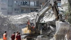 Rescue workers search the rubble of a building annexed to the Iranian embassy in Damascus 