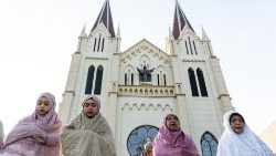 Peaceful coexistence among religions in Indonesia seen as Muslims marked the end of Ramadan, on the grounds of the Sacred Heart of Jesus Catholic Church due to their nearby mosque being full (10 April) 