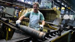 An employee handles 155mm caliber shells after being manufactured in Pennsylvania, US