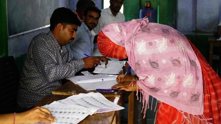  A woman registers to cast her ballot at a polling station during the first phase of voting for the India's general elections