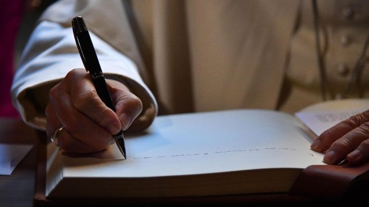 Pope Francis writing