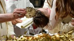 A baby is baptized in the Sistine Chapel