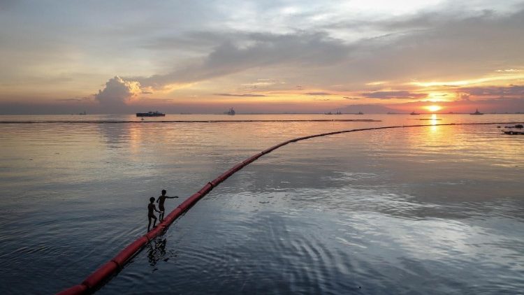 File photo of children playing along a divider in Manila Bay in Manila, Philippines.