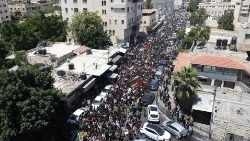 Hundreds of Palestinian mourners join a funeral procession in Jenin