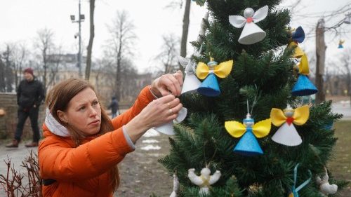 Ukrainians in Kyiv decorate a Christmas tree with angels and hearts symbolizing those killed in the Maidan uprising (2013-14) and in the ongoing war with Russia