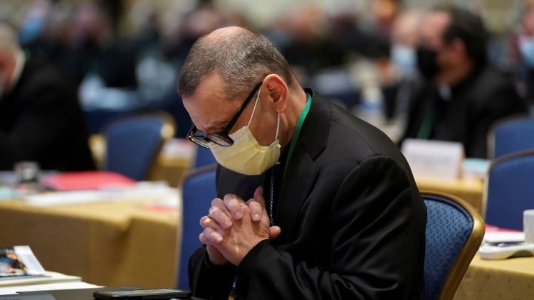 File photo of a US bishop praying during an annual meeting of the USCCB