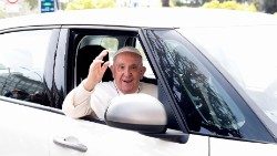 Pope Francis waves from a car as he leaves Rome's Gemelli hospital in Rome