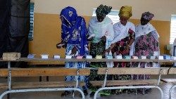 Voters collect their ballots at a polling station in Mbour, Senegal