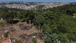 A drone view shows the city and an area under permanent protection that was illegally deforested, in Aruja
