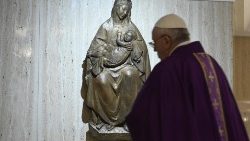 Pope Francis with a statue of Our Lady during Mass at the Casa Santa Marta