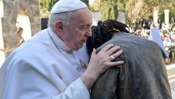 Pope Francis embraces a migrant during an apostolic visit to Malta