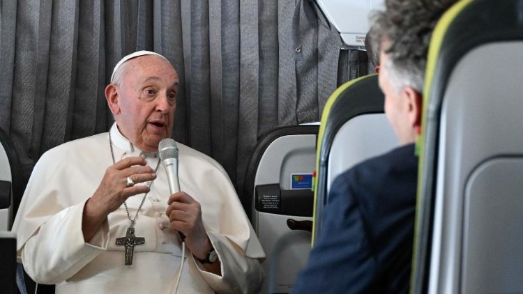 Pope Francis speaking to reporters on his way back to Rome from Lisbon