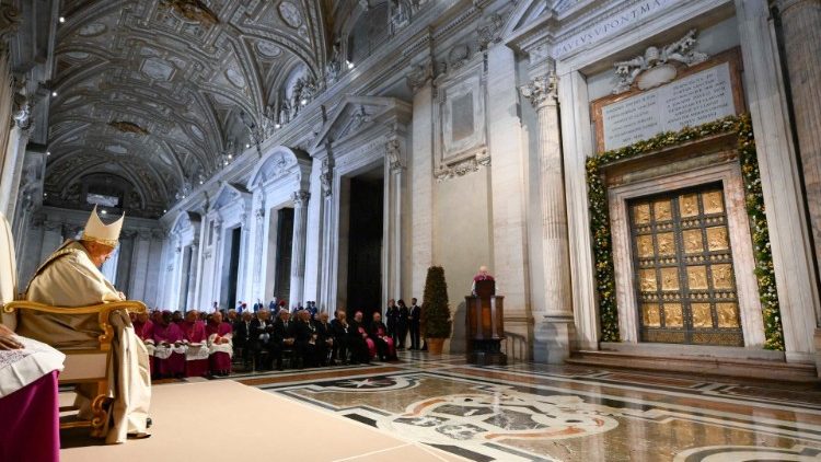 Pope Francis contemplates the Holy Door in St. Peter's Basilica 