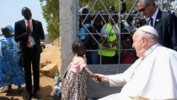 Pope Francis takes the hand of a young South Sudanese during his visit to Juba
