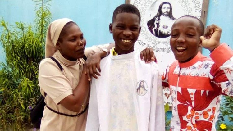 A Sister of Charity with young people in Gabon