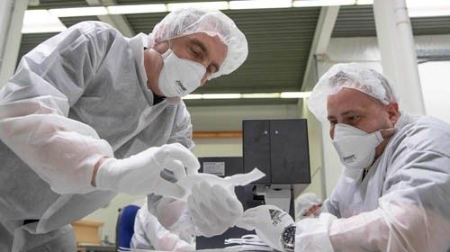 Employees of Zender Germany GmbH textile company, an automotive supplier, make protective masks to ...