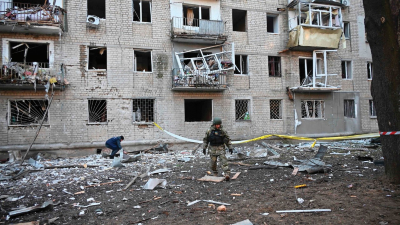 TOPSHOT - A rescuer works outside a residential building damaged as a result of Russian strikes in ...