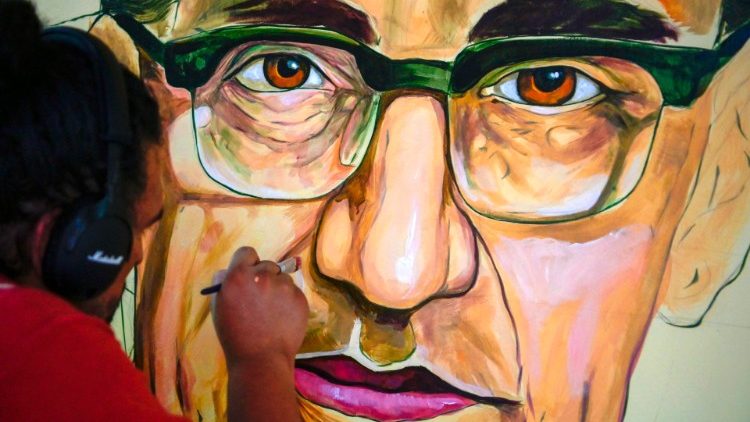Romacho Melgar maluje portrét Oscara Romera na nástěnné malbě ve Středoamerické univerzitě v San Salvadoru
