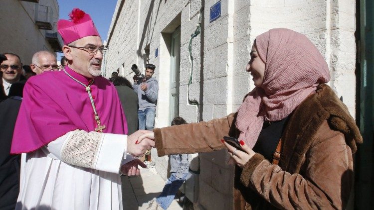 Mgr Pizzaballa accueilli par une femme palestinienne lors de sa venue à Bethléem le 24 décembre dernier, pour les célébrations de la Nativité 