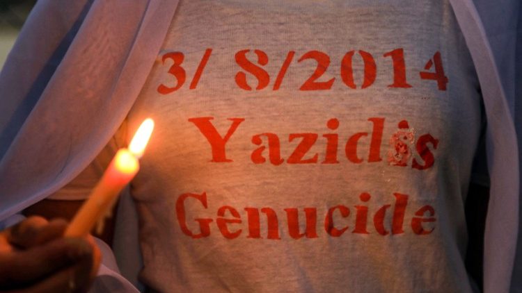 Iraqi Yazidis mark a candlelight vigil recalling the massacre of their community by IS in 2014