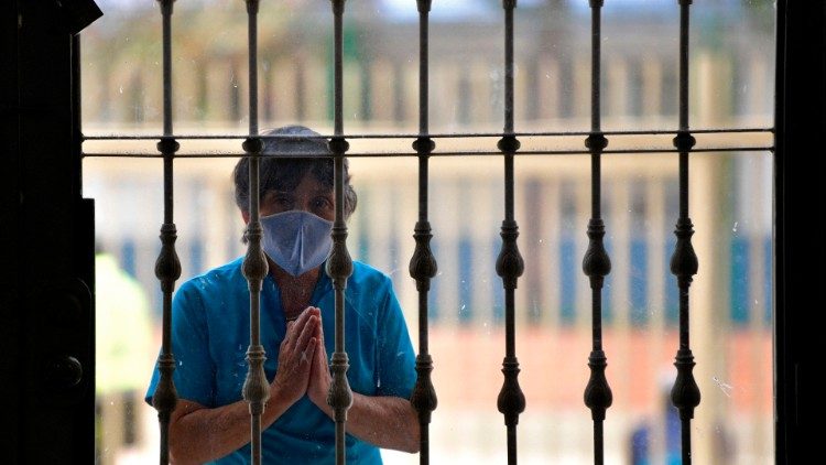 A man prays outside a church in Colombia
