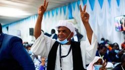 At the signing ceremony of the Sudan peace deal held, Monday, in Juba, South Sudan, a man makes the peace sign