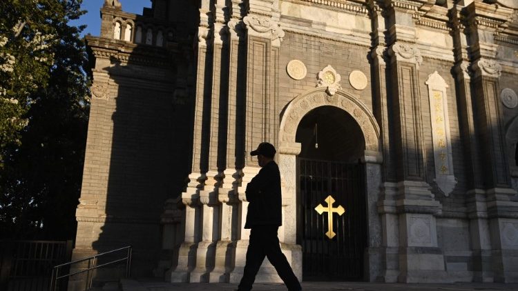A man walks past a Catholic Church in China