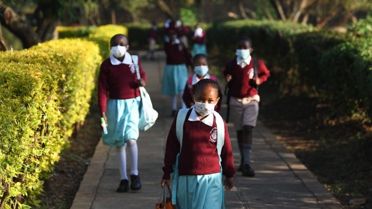 Children in Kenya return to school wearing facemasks