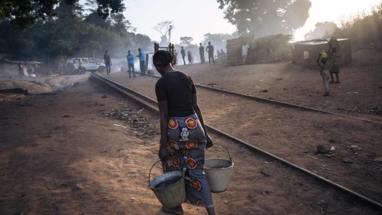 CAR: A woman carries water from the river to the refugee site of Ndu, Bas-Uele Province in the DRC