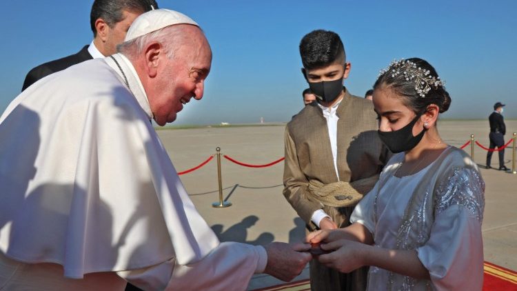Pope Francis is greeted by an Iraqi woman upon his arrival at Erbil airport