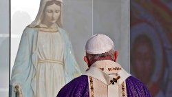 File photo of Pope Francis praying before a statue of Mary in the Iraqi city of Erbil