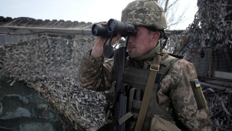 A Ukrainian soldier patrols a checkpoint near Mariupol, in eastern Ukraine