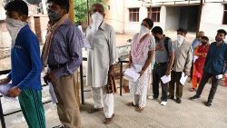 People stand in a queue to register for a Covid test at a hospital in India