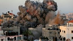 A ball of fire and smoke erupts from a building in Gaza city on Sunday amid bombardment from Israeli forces