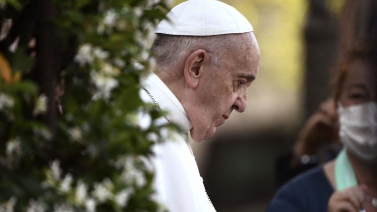 Pope Francis bows his head in prayer at a service in the Vatican Gardens