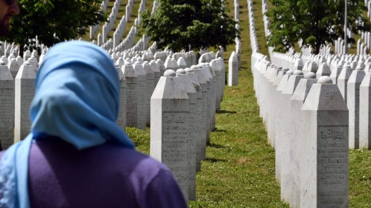 A woman standing near the tombstones in the Memorial cemetery in Potocari-Srebrenica that honours the victims of the 1995 Srebrenica massacre.