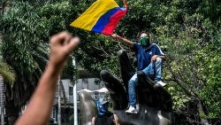 A man waves a flag during protests in Medellin, Colombia