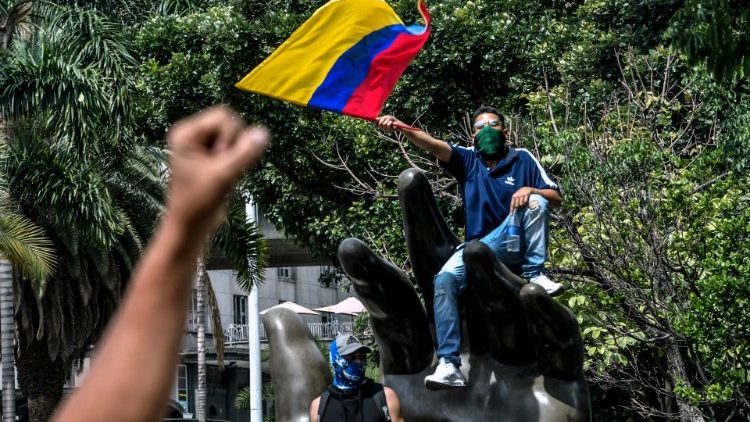 A man waves a flag during protests in Medellin, Colombia