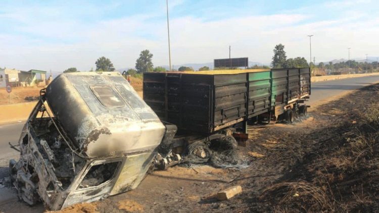 A burnt truck on the side of the road amid protests in Manzini, Eswatini 
