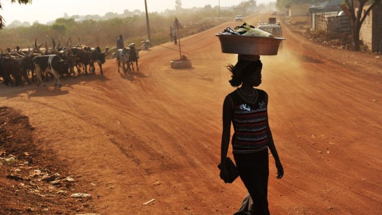 A resident walks on an unpaved road in Juba