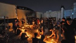 Mourners observing a vigil for the victims of the fire in the Covid-19 ward of a hospital in Nasiriyah, Iraq. 