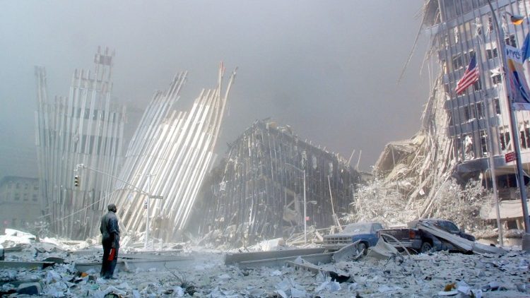 A survivor stands in front of the wreckage of the World Trade Center on September 11, 2001